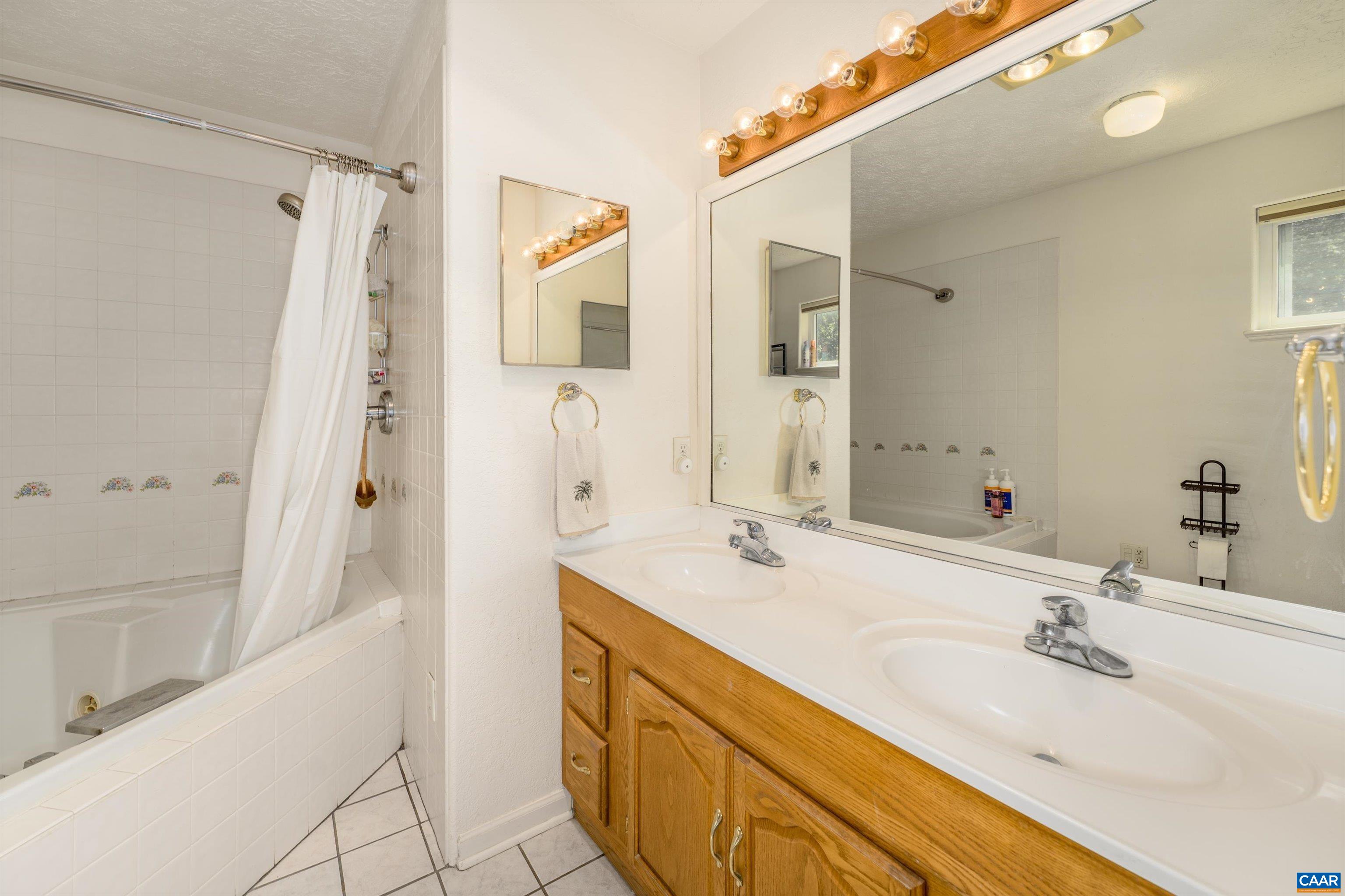 15365 Madison Run Road Gordonsville, VA 22942 - Photo 18 of 38 a bathroom with a tub sink and mirror