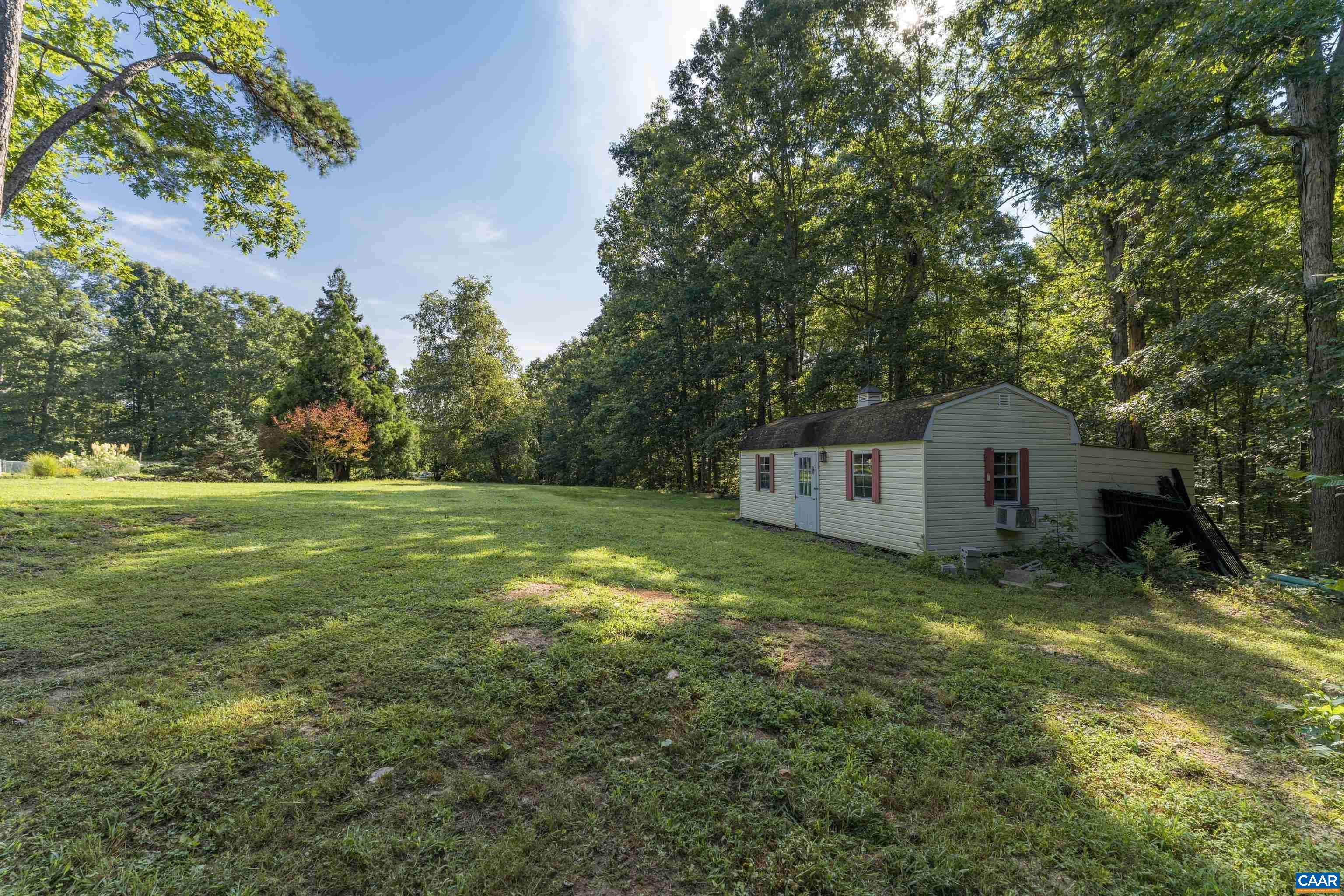 15365 Madison Run Road Gordonsville, VA 22942 - Photo 34 of 38 a house is sitting in middle of the green field