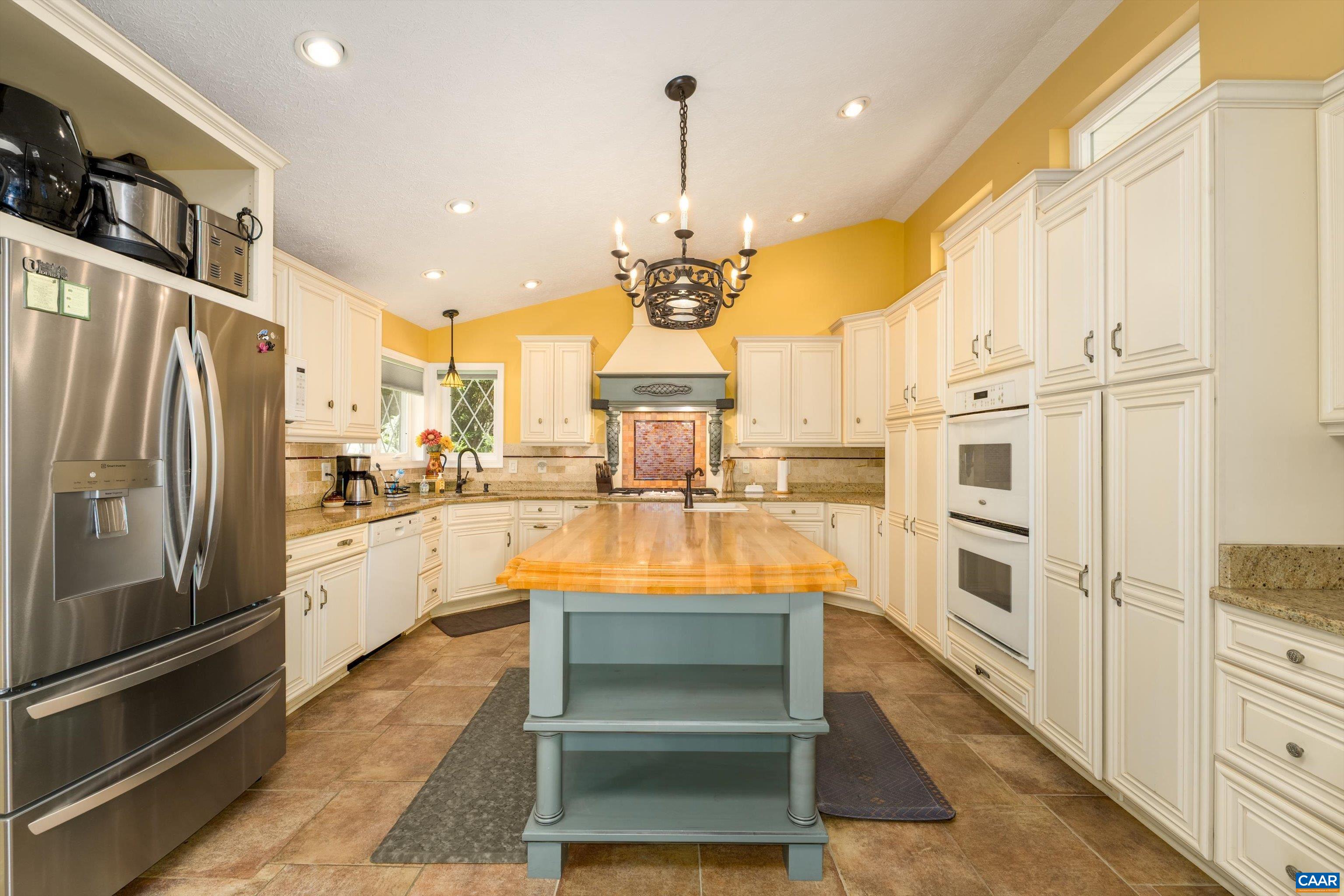 15365 Madison Run Road Gordonsville, VA 22942 - Photo 5 of 38 a large kitchen with stainless steel appliances kitchen island granite countertop a refrigerator and a stove