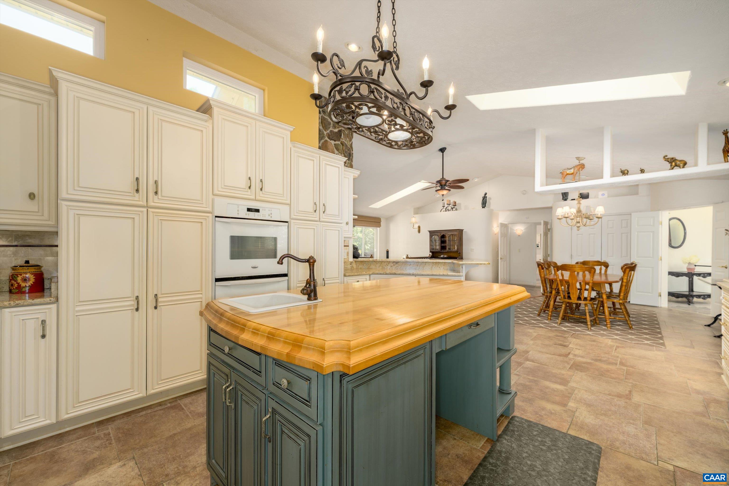 15365 Madison Run Road Gordonsville, VA 22942 - Photo 8 of 38 a kitchen with stainless steel appliances kitchen island granite countertop a table and chairs in it