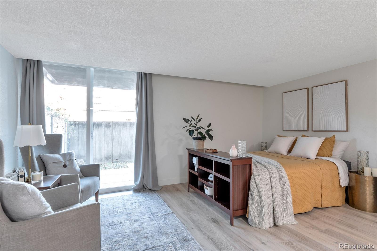 2500 South York Street, Unit 107 Denver, CO 80210 - Photo 2 of 21 a bed room with a bed and a couch