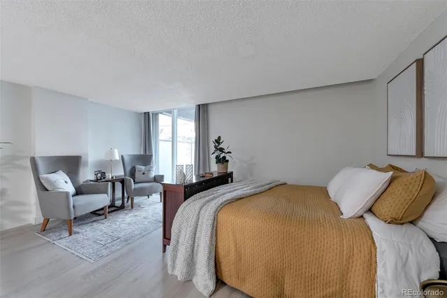 a bedroom with a bed and lamp