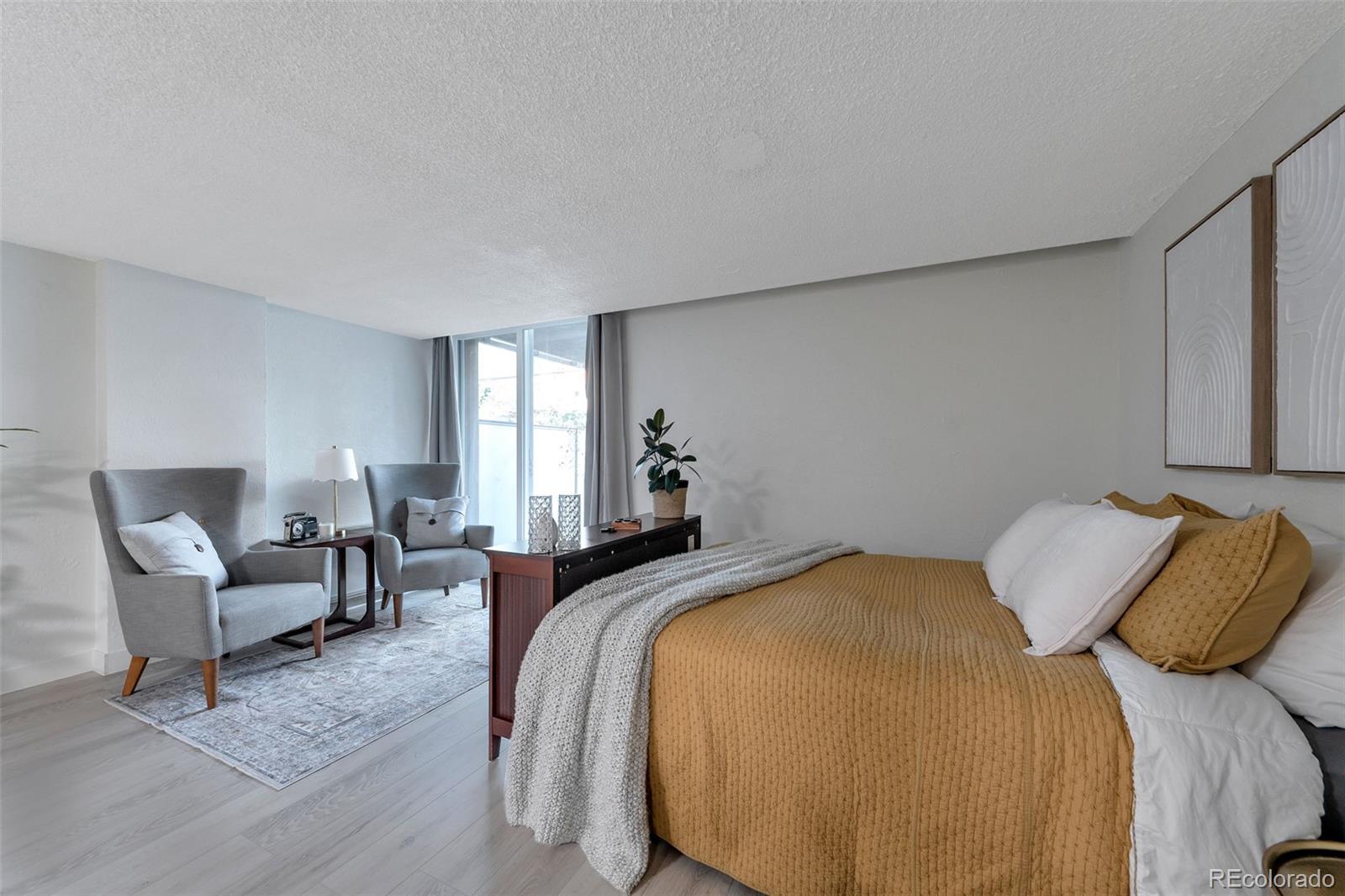 2500 South York Street, Unit 107 Denver, CO 80210 - Photo 3 of 21 a bedroom with a bed and lamp