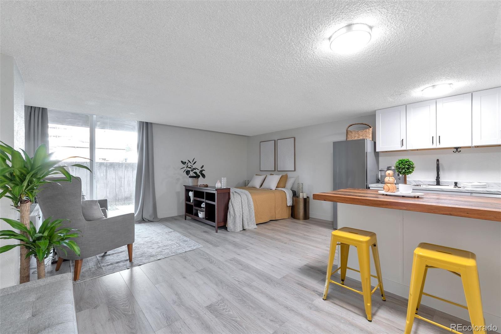2500 South York Street, Unit 107 Denver, CO 80210 - Photo 7 of 21 a living room with furniture and potted plants with wooden floor