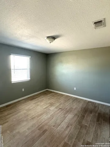 an empty room with a empty space and windows