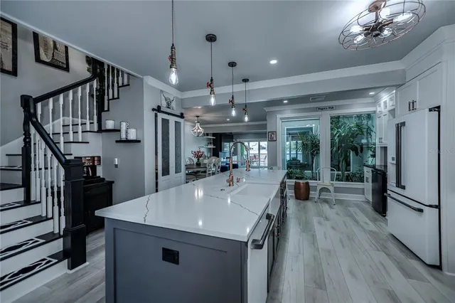 a kitchen with a sink stainless steel appliances and cabinets