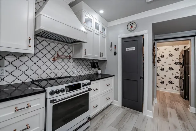 a kitchen with stainless steel appliances a stove refrigerator sink and cabinets