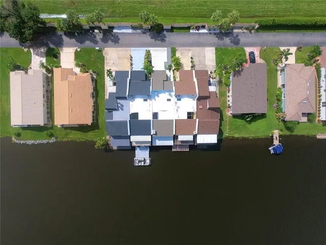 an aerial view of a house with outdoor space lake view and sitting space
