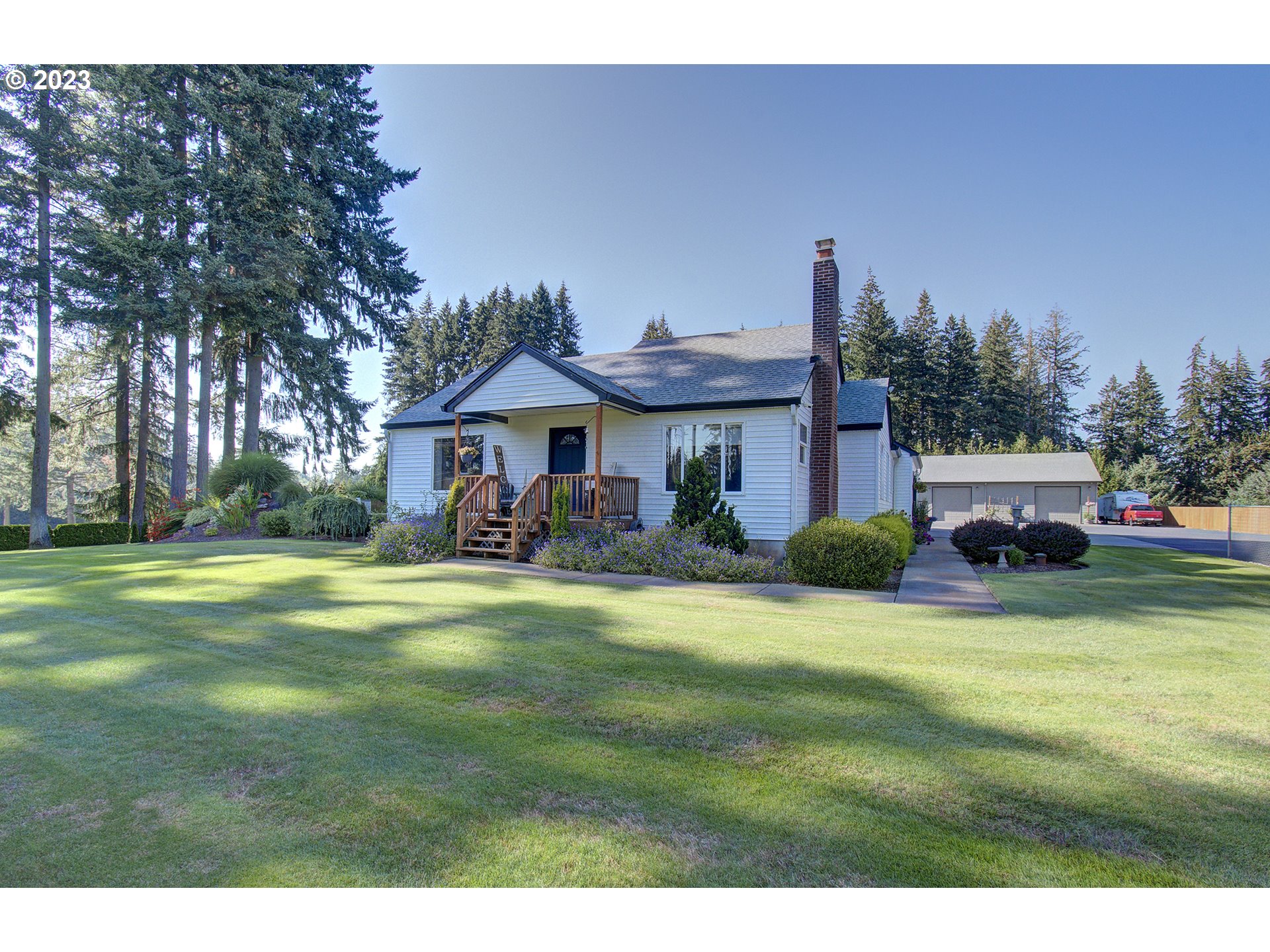 4702 Northeast 199th Street Ridgefield, WA 98642 - Photo 1 of 32 a front view of a house with swimming pool having outdoor seating