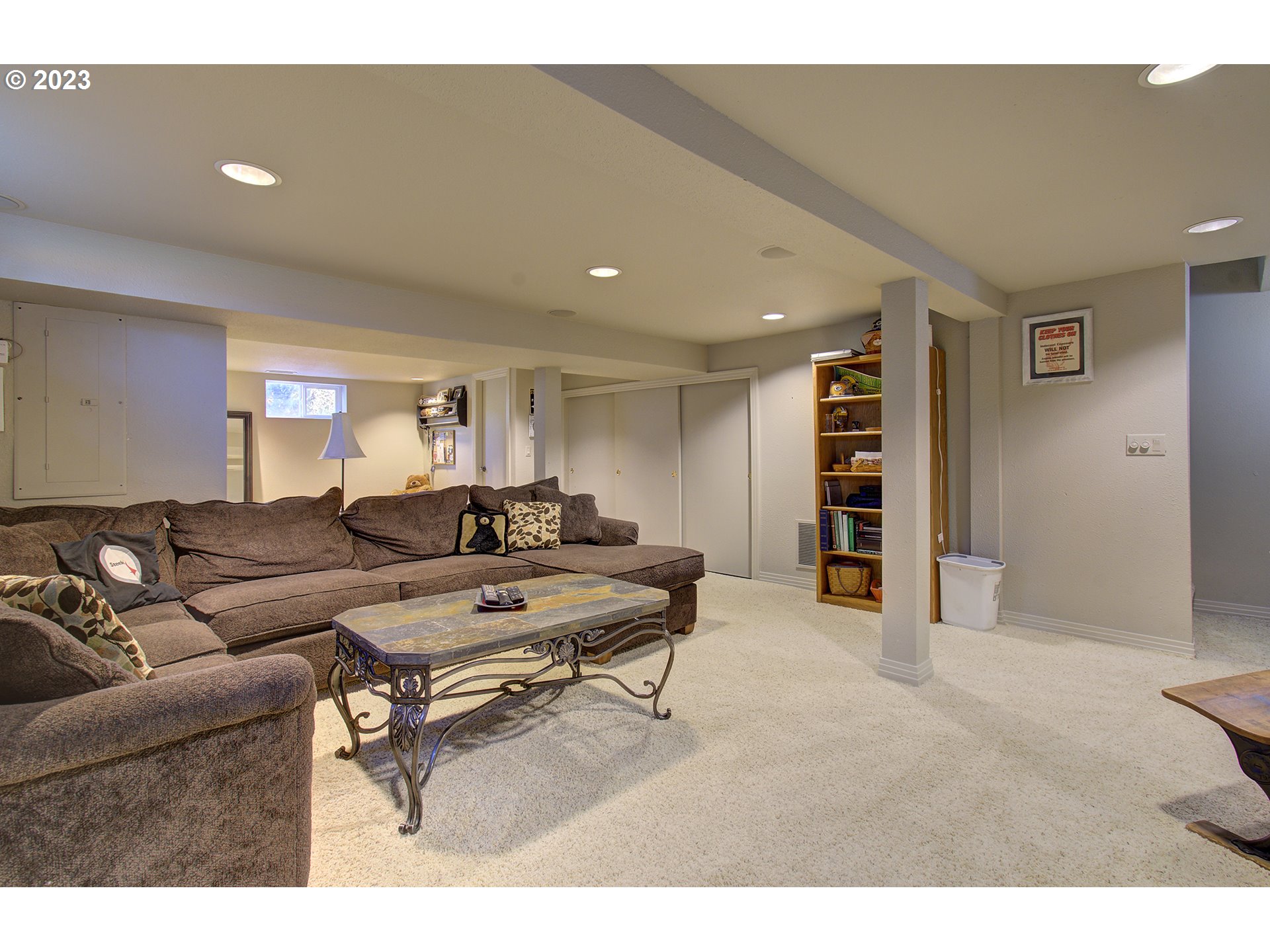 4702 Northeast 199th Street Ridgefield, WA 98642 - Photo 13 of 32 a living room with furniture a piano and a bookshelf