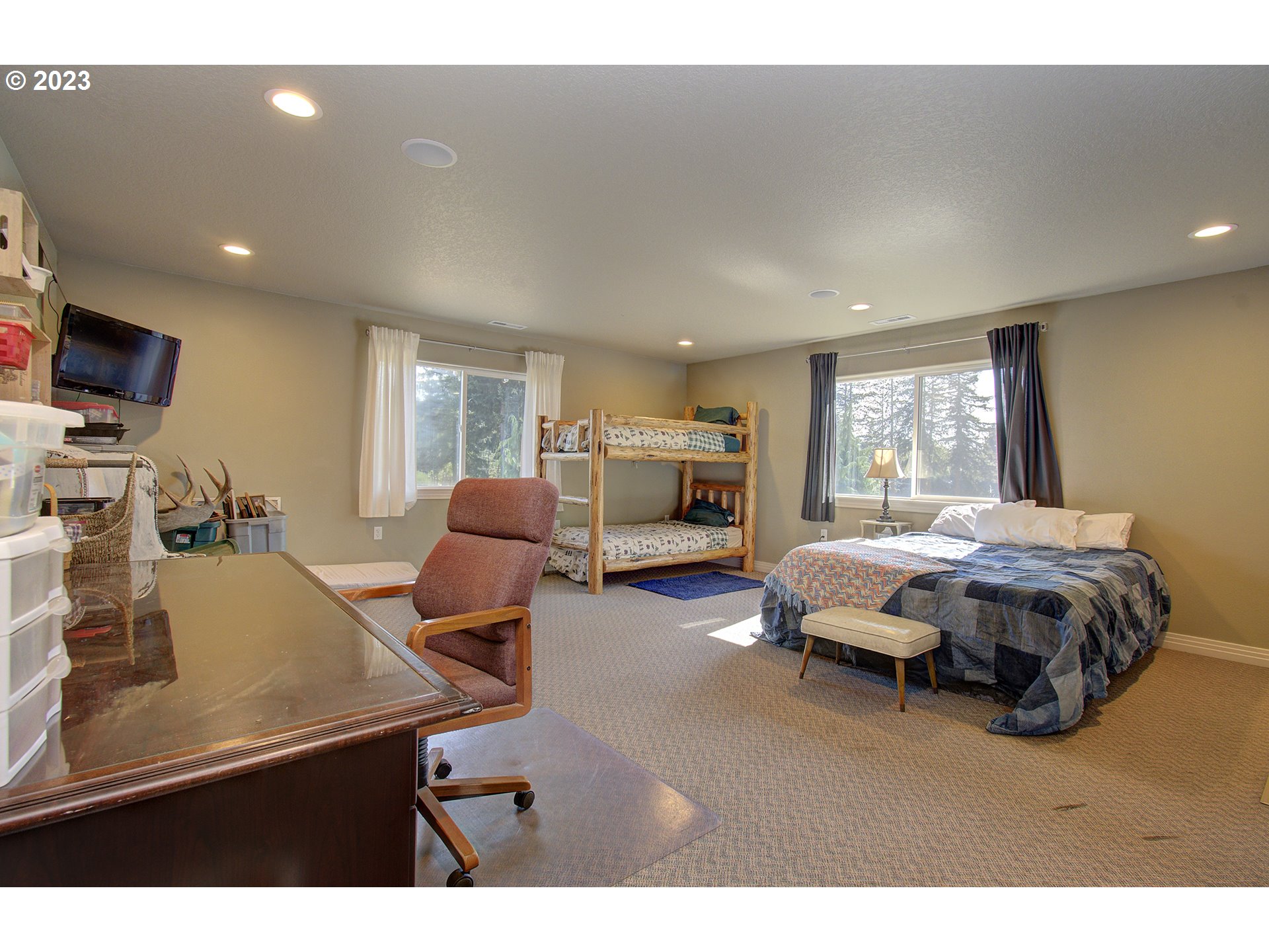 4702 Northeast 199th Street Ridgefield, WA 98642 - Photo 24 of 32 a bedroom with furniture and a flat screen tv