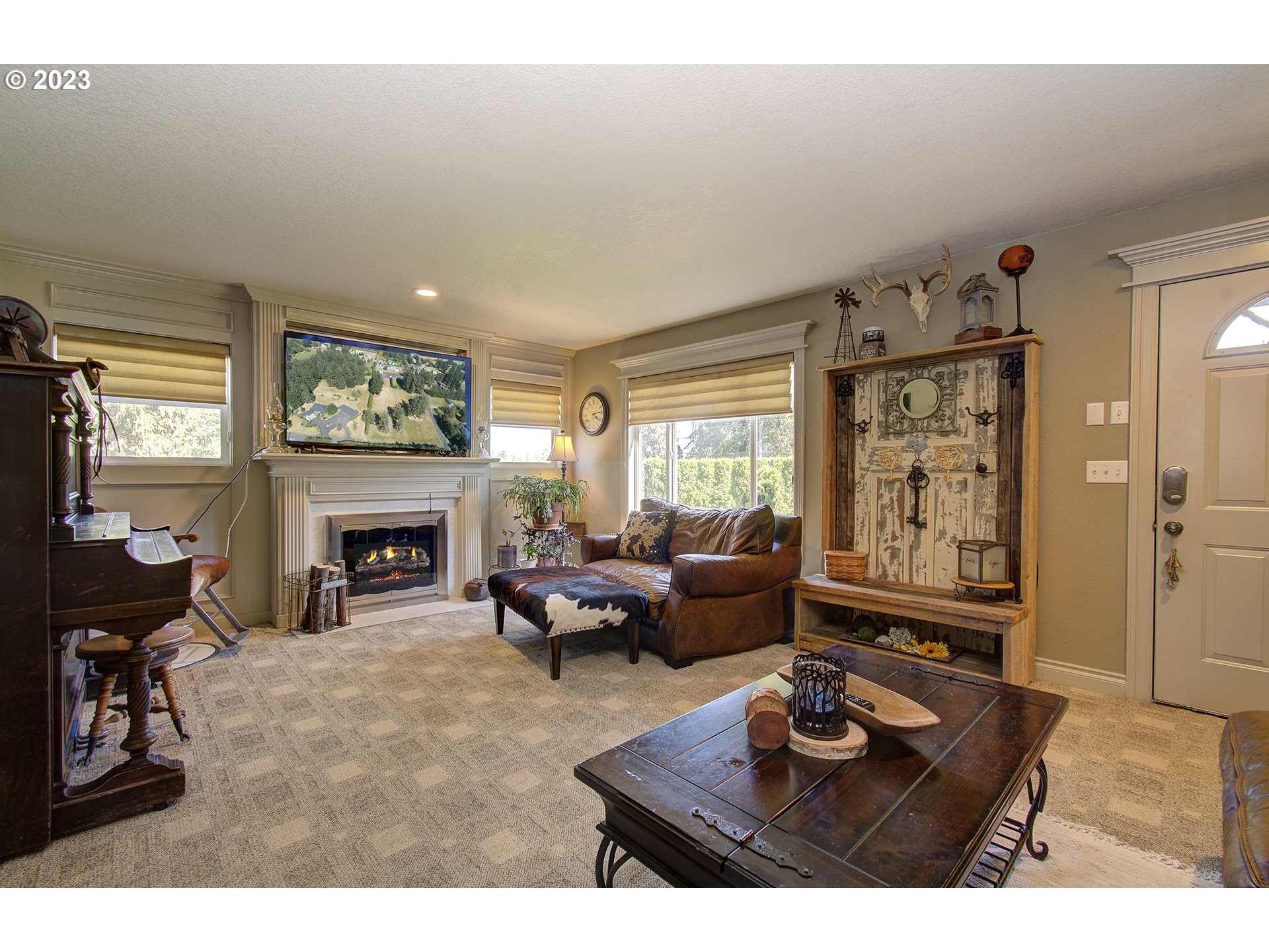 4702 Northeast 199th Street Ridgefield, WA 98642 - Photo 5 of 32 a living room with furniture a fireplace and a large window