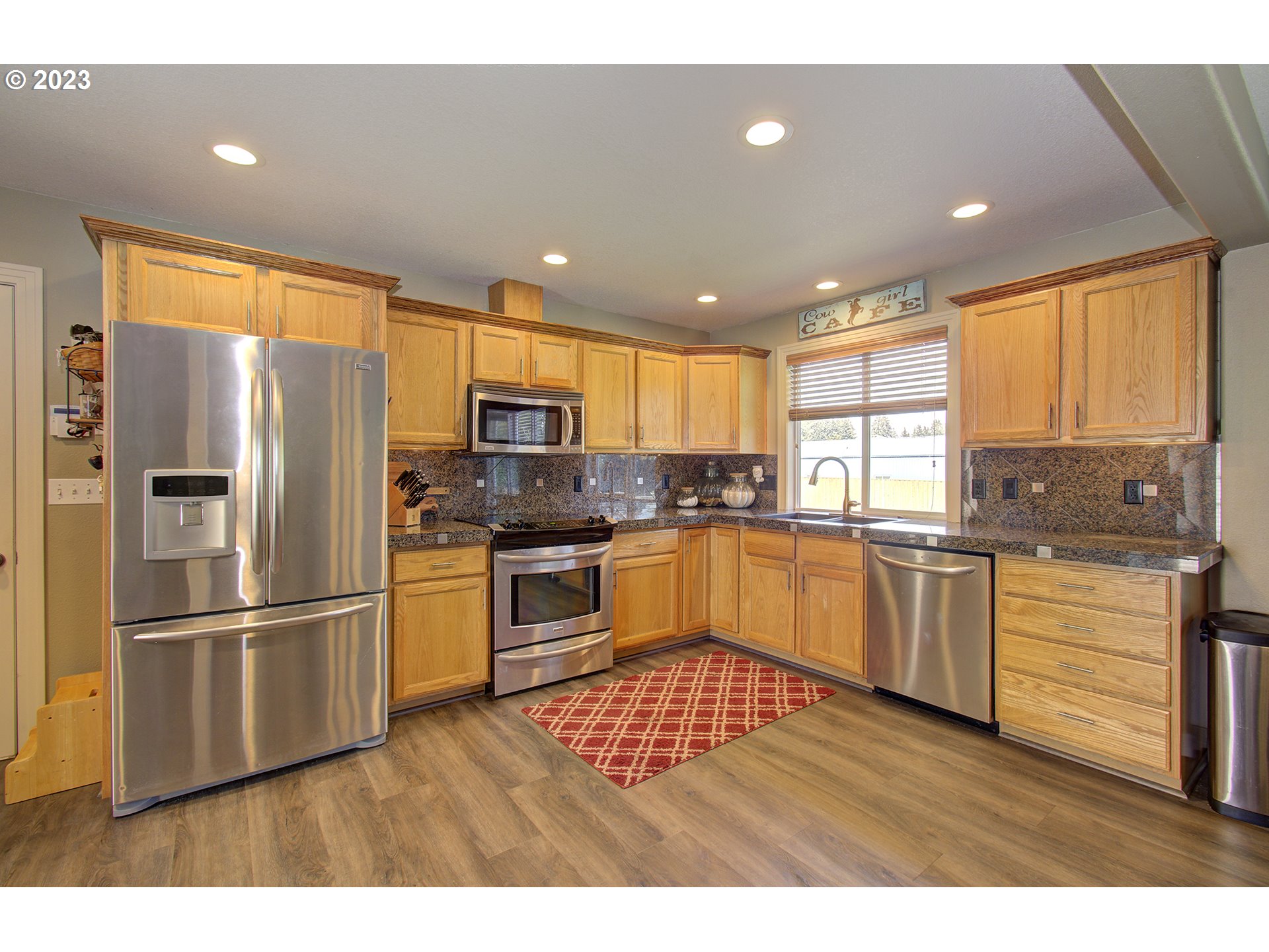 4702 Northeast 199th Street Ridgefield, WA 98642 - Photo 6 of 32 a kitchen with granite countertop a refrigerator stove top oven and sink