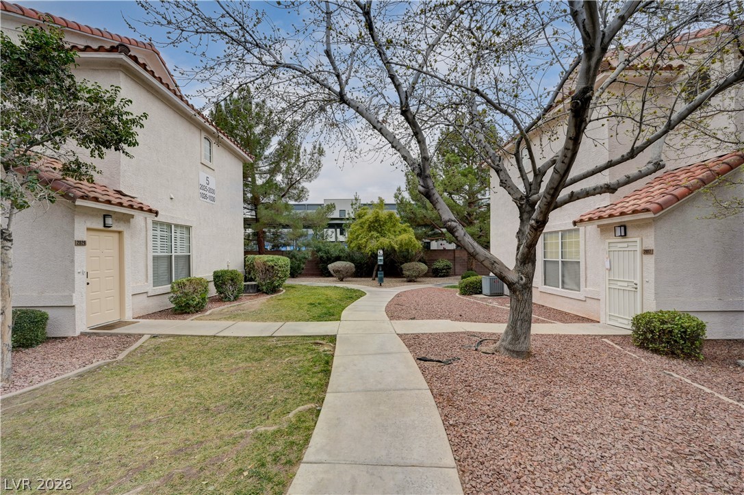 8555 West Russell Road, Unit 1017 Las Vegas, NV 89113 - Photo 26 of 34 A welcoming courtyard with manicured landscaping leads to private entryways.