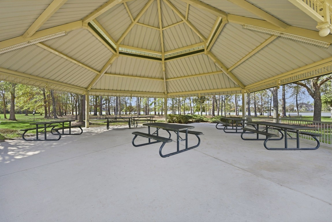 27560 South Lazy Meadow Way Spring, TX 77386 - Photo 37 of 42 a view of a patio with table and chairs under an umbrella