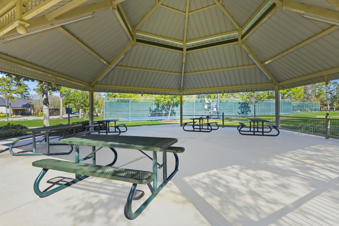 27560 South Lazy Meadow Way Spring, TX 77386 - Photo 39 of 42 a view of a patio with a table and chairs under an umbrella