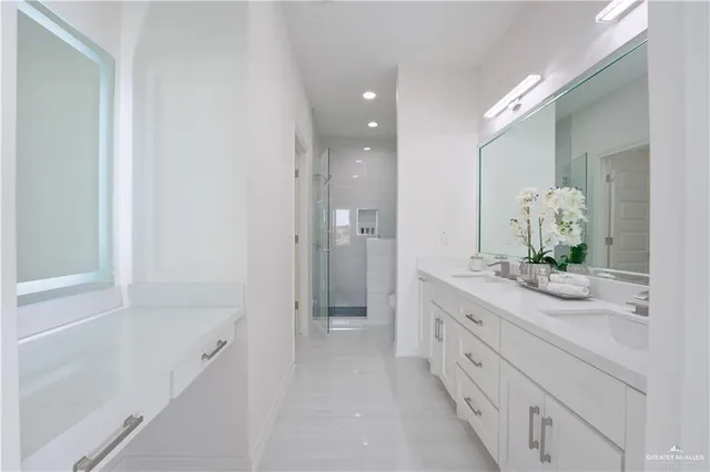 a spacious bathroom with a granite countertop sink and a mirror