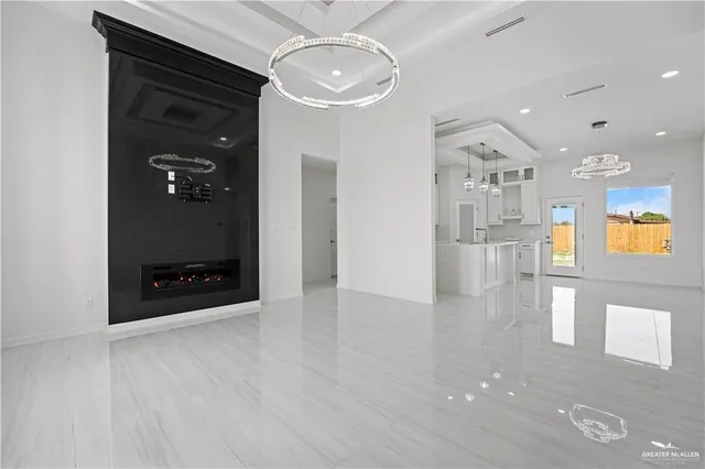 a view of a hallway with wooden floor and a living room