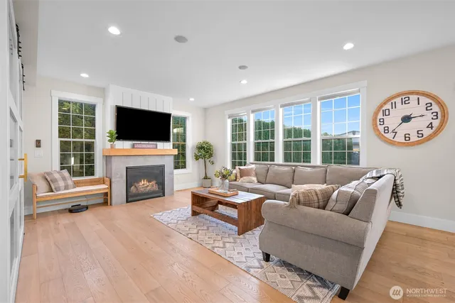 a living room with furniture a fireplace and a flat screen tv