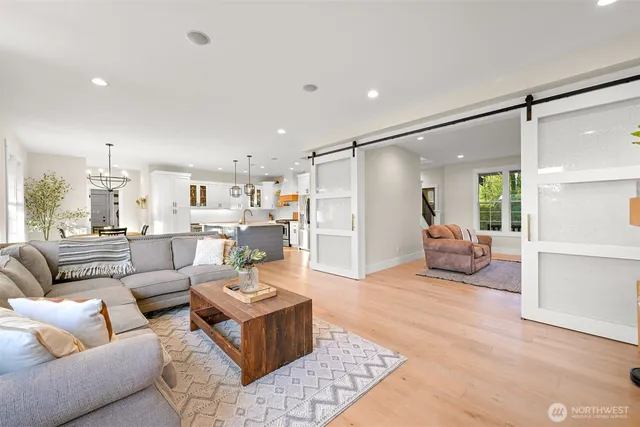 a living room with furniture and a view of kitchen