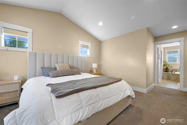 a bedroom with a bed and a mirror