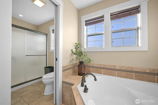 a bathroom with a tub and shower