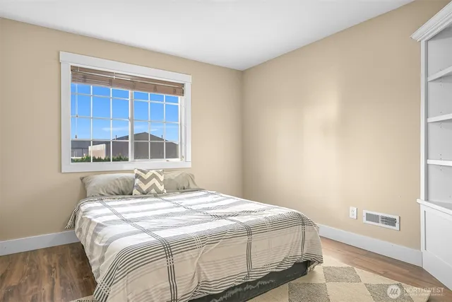 a bedroom with a bed and a window