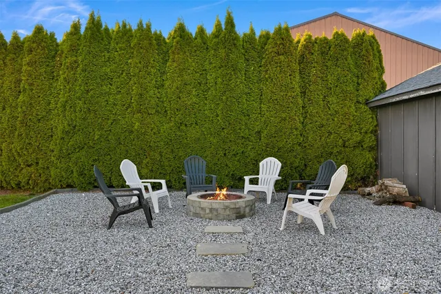 a backyard of a house with table and chairs