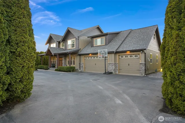 a view of a house with a yard and garage