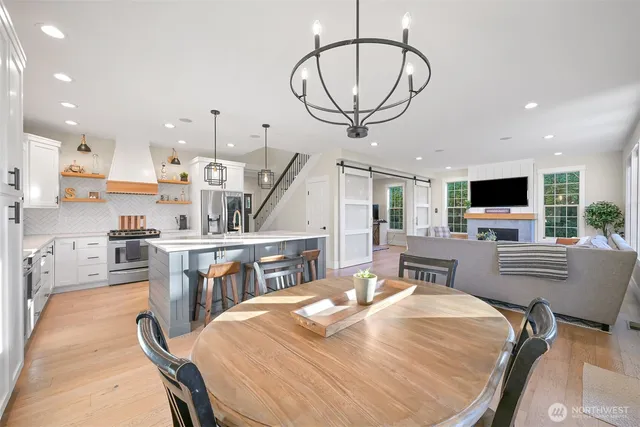 a kitchen with stainless steel appliances kitchen island granite countertop a sink and cabinets