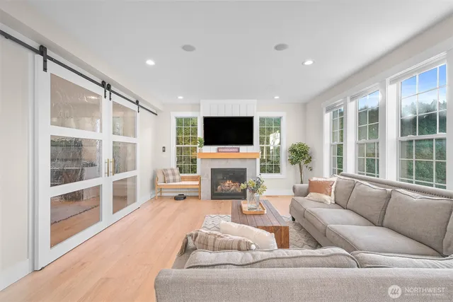 a living room with fireplace furniture and a flat screen tv