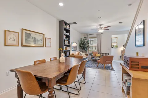a view of a dining room with furniture and a chandelier