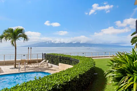 a view of a swimming pool with a table and chairs