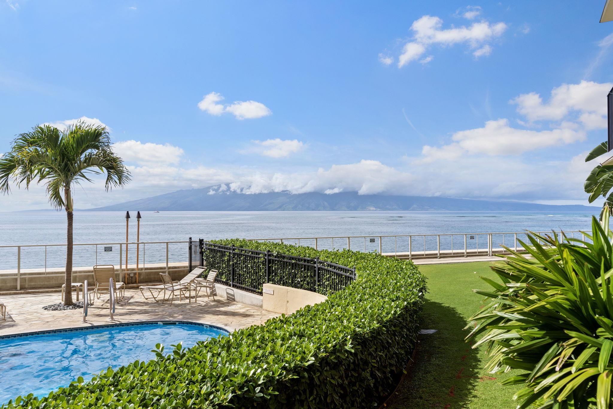 4401 Lower Honoapiilani Road, Unit A101 Lahaina, HI 96761 - Photo 22 of 37 a view of a swimming pool with a table and chairs
