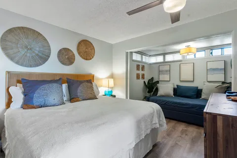 a bedroom with a large bed and a chandelier