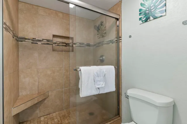 a bathroom with a toilet and a shower