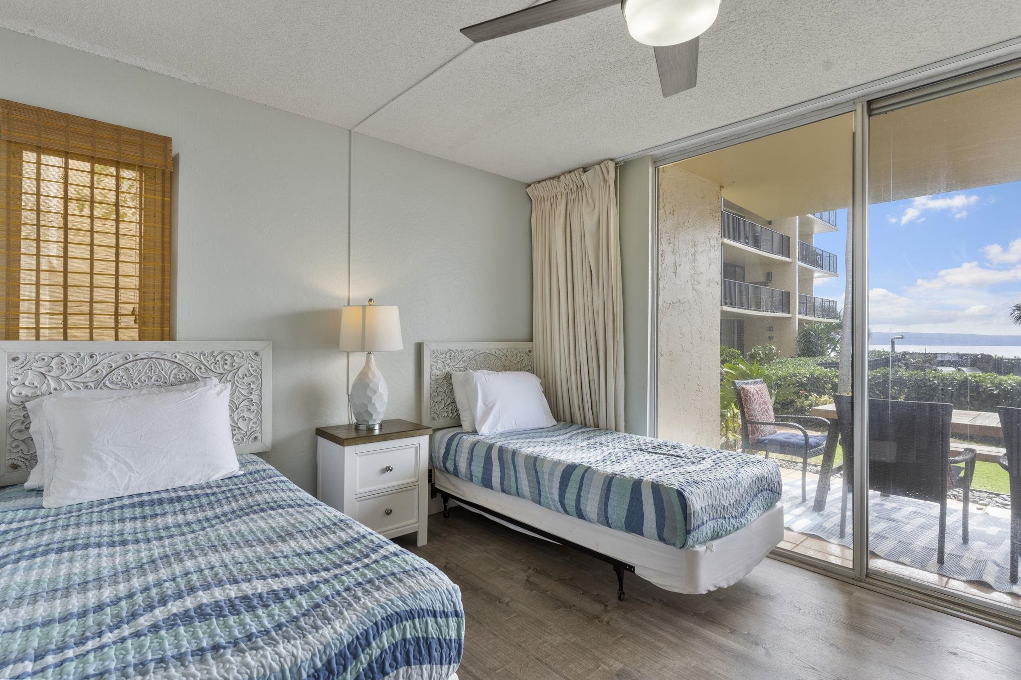 4401 Lower Honoapiilani Road, Unit A101 Lahaina, HI 96761 - Photo 29 of 37 a bedroom with a bed and large window