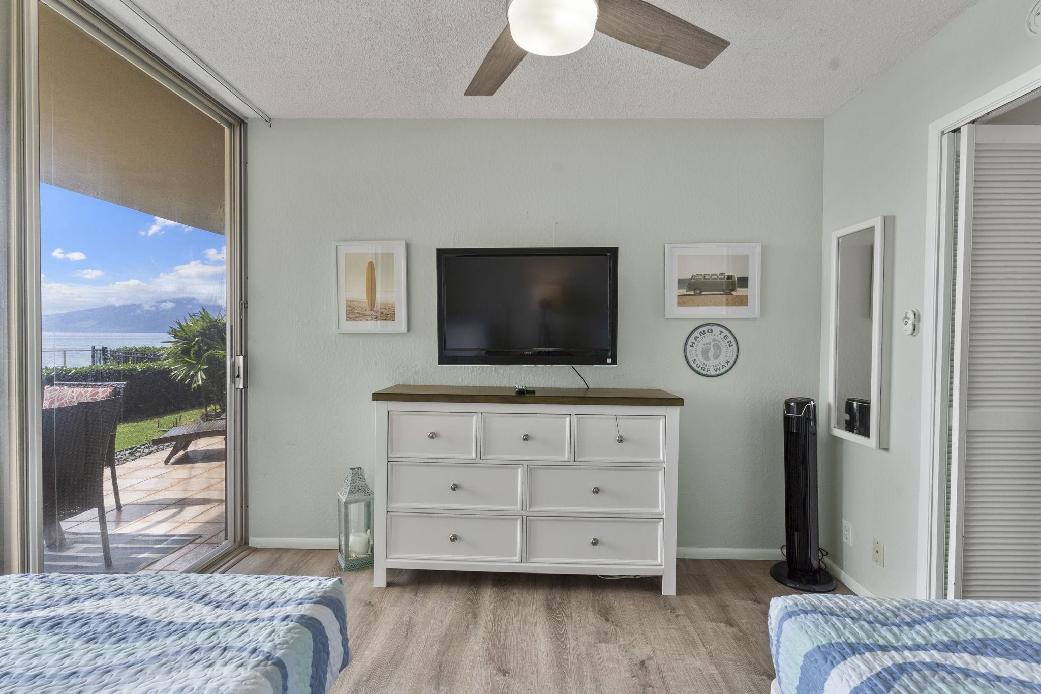 4401 Lower Honoapiilani Road, Unit A101 Lahaina, HI 96761 - Photo 30 of 37 a bedroom with a bed and a flat screen tv