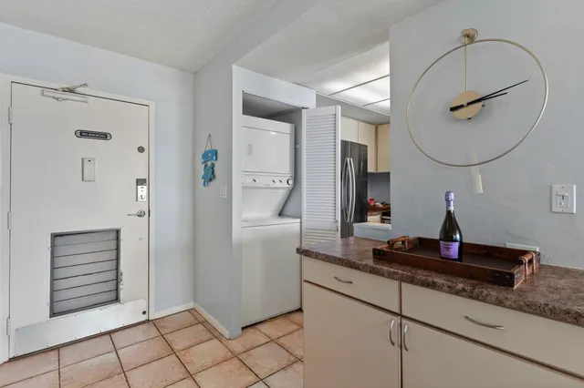a living room with a mirror and a wooden floor