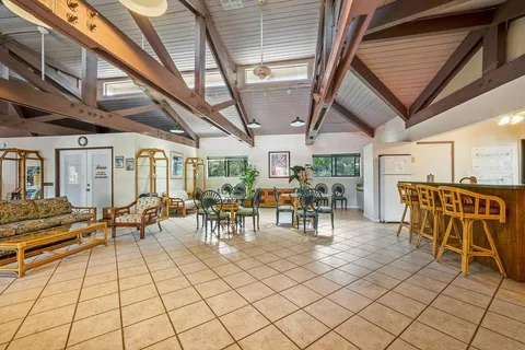a view of a patio with table and chairs