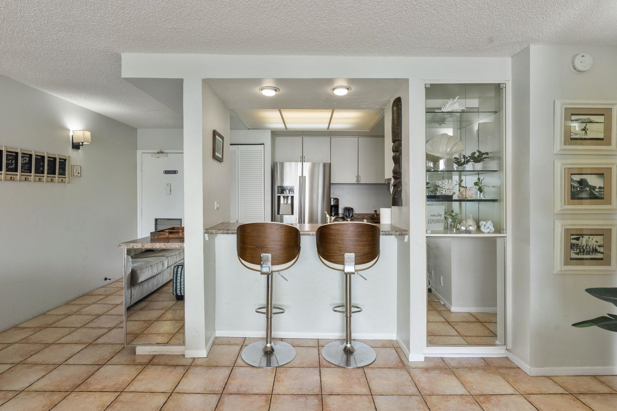 4401 Lower Honoapiilani Road, Unit A101 Lahaina, HI 96761 - Photo 8 of 37 a kitchen with stainless steel appliances kitchen island granite countertop a refrigerator and a sink
