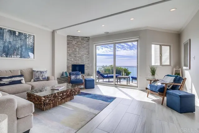a living room with furniture large window and a fireplace