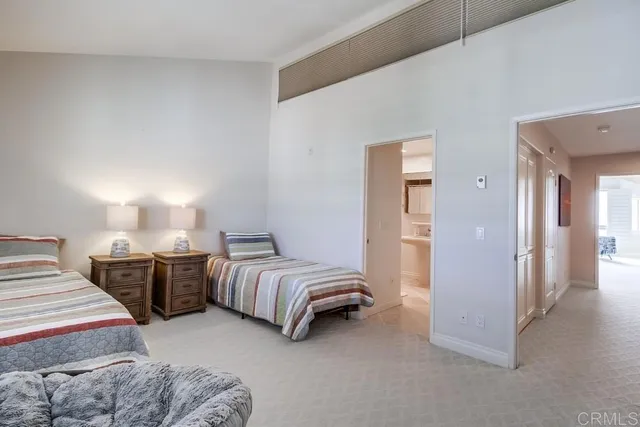 a bedroom with two beds and painted walls