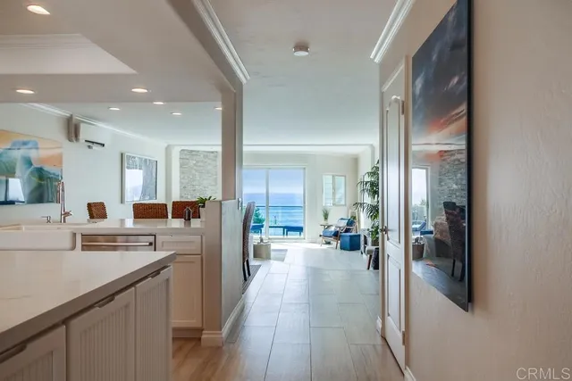 a kitchen with stainless steel appliances a refrigerator a sink dishwasher stove and oven with wooden floor