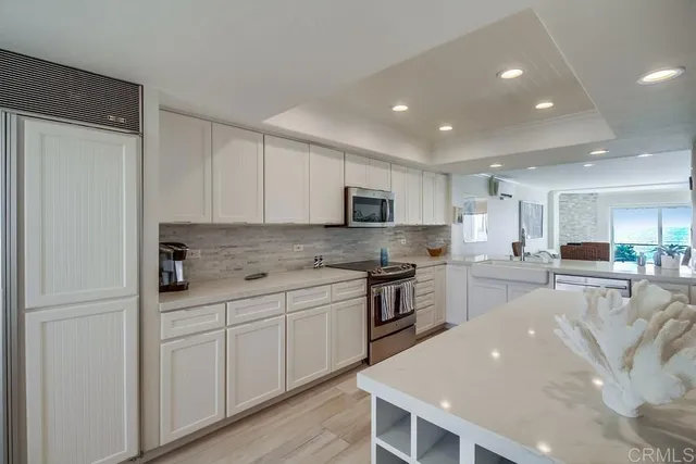 a kitchen with stainless steel appliances granite countertop a refrigerator sink and cabinets