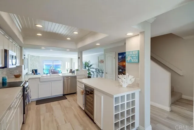 a kitchen with kitchen island a sink stove and wooden floor