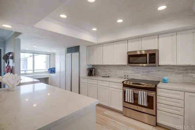 a kitchen with stainless steel appliances a stove sink microwave and cabinets