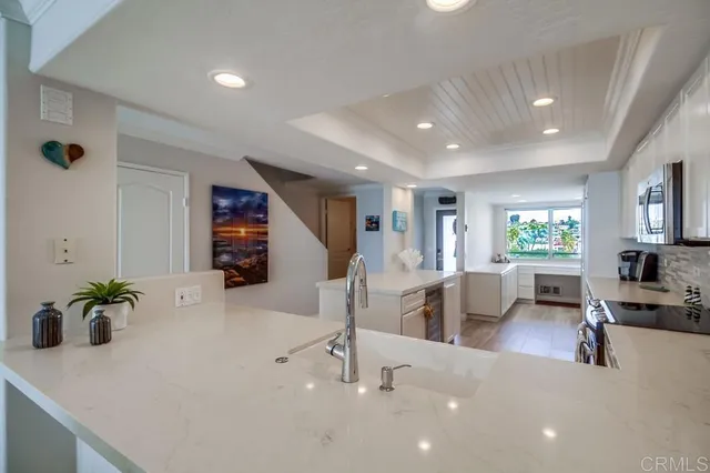a living room with furniture a potted plant and a table