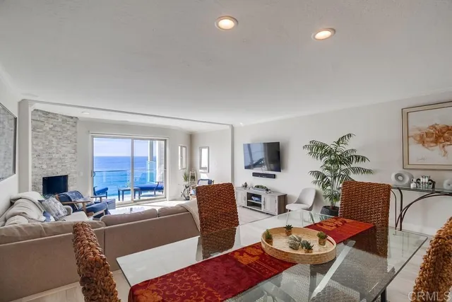 a living room with furniture a fireplace and a window