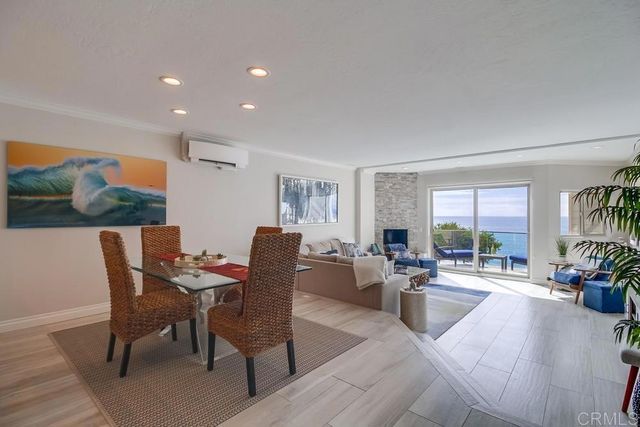 a living room with fireplace furniture and a large window